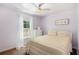 This cozy bedroom features a ceiling fan and a large window for natural light at 6195 Queensdale Dr, Douglasville, GA 30135