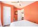 The bedroom showcases a white bed, peach walls, and access to a closet and additional room at 6195 Queensdale Dr, Douglasville, GA 30135