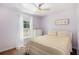 Cozy bedroom with soft natural light, a comfortable bed, and a view of the outdoors at 6195 Queensdale Dr, Douglasville, GA 30135