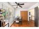 Bright dining area with natural light, a table setting for four, and stainless steel appliances at 6195 Queensdale Dr, Douglasville, GA 30135