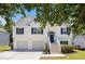 Charming two-story home featuring a two-car garage, black shutters, and a welcoming front porch with stairs at 6195 Queensdale Dr, Douglasville, GA 30135