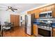 Well-lit kitchen features stainless steel appliances, wood cabinetry, and a dining area with seating for four at 6195 Queensdale Dr, Douglasville, GA 30135