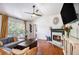 Bright living room featuring hardwood floors, fireplace, vaulted ceilings, and large windows providing natural light at 6195 Queensdale Dr, Douglasville, GA 30135