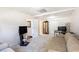 Spacious living room area with a beige couch, large tv, and lots of storage at 6195 Queensdale Dr, Douglasville, GA 30135