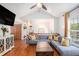 Bright living room with hardwood floors, comfortable sectional sofa, and view to the dining area at 6195 Queensdale Dr, Douglasville, GA 30135