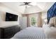 Main bedroom showcases a tray ceiling, accent wall, a large window and a mounted television at 6195 Queensdale Dr, Douglasville, GA 30135
