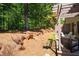 Backyard with a stone wall, mature trees, and lush greenery at 2470 Anderson Estates Ct, Marietta, GA 30064