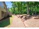 Scenic backyard showing a retaining wall, trees, and lush greenery at 2470 Anderson Estates Ct, Marietta, GA 30064