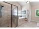 Bright bathroom featuring a walk-in shower, tub with a large window, and neutral tile at 2470 Anderson Estates Ct, Marietta, GA 30064