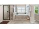 Beautiful bathroom featuring a glass shower and a soaking tub with natural light at 2470 Anderson Estates Ct, Marietta, GA 30064