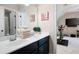 Bright bathroom with double vanity, modern fixtures, and view into the exercise room at 2470 Anderson Estates Ct, Marietta, GA 30064