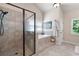 Bright bathroom features a soaking tub, a large walk-in shower, and neutral stone-look tile at 2470 Anderson Estates Ct, Marietta, GA 30064