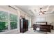 Bedroom featuring a stylish armoire, ceiling fan, and views of the surrounding trees at 2470 Anderson Estates Ct, Marietta, GA 30064