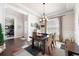 Bright dining room features elegant trim, a stylish chandelier, and a rustic wooden table at 2470 Anderson Estates Ct, Marietta, GA 30064