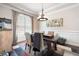 Formal dining room with tray ceilings, modern chandelier, and large windows at 2470 Anderson Estates Ct, Marietta, GA 30064