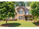 Charming brick home with a lush green lawn and mature trees in a desirable neighborhood at 2470 Anderson Estates Ct, Marietta, GA 30064