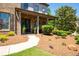 Inviting front porch with stone accents, manicured landscaping, and a cozy seating area at 2470 Anderson Estates Ct, Marietta, GA 30064