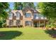 Elegant two-story home boasting a manicured lawn, complemented by lush landscaping and a welcoming front porch at 2470 Anderson Estates Ct, Marietta, GA 30064