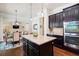 Bright kitchen showcasing a granite island, stainless steel appliances, and dark cabinets with hardwood flooring at 2470 Anderson Estates Ct, Marietta, GA 30064