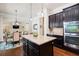 Open concept kitchen with large center island, stainless steel appliances, and dark wood cabinets at 2470 Anderson Estates Ct, Marietta, GA 30064