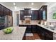 Well-equipped kitchen featuring dark wood cabinets, stainless steel appliances and granite countertops at 2470 Anderson Estates Ct, Marietta, GA 30064