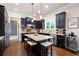 Gourmet kitchen with dark cabinets, granite countertops, and an island with seating at 2470 Anderson Estates Ct, Marietta, GA 30064