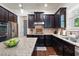 Well-lit kitchen features granite countertops, stainless steel appliances and dark wood cabinetry at 2470 Anderson Estates Ct, Marietta, GA 30064