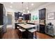 Gourmet kitchen with granite countertops, stainless steel appliances, and a center island with bar stools at 2470 Anderson Estates Ct, Marietta, GA 30064