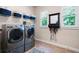 Spacious laundry room with front loading washer and dryer and ample storage space at 2470 Anderson Estates Ct, Marietta, GA 30064
