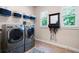Well-equipped laundry room with modern appliances and ample storage, including overhead shelving at 2470 Anderson Estates Ct, Marietta, GA 30064