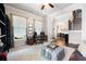 Bright living room featuring a decorative fireplace, hardwood floors, and large windows at 2470 Anderson Estates Ct, Marietta, GA 30064