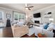 Comfortable living room with a fireplace, TV, and sliding glass door to the backyard at 2470 Anderson Estates Ct, Marietta, GA 30064