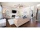 Open living room features a fireplace, hardwood floors, a comfortable sofa, and a staircase at 2470 Anderson Estates Ct, Marietta, GA 30064