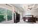 Well-lit main bedroom with tray ceiling, ceiling fan, and large windows at 2470 Anderson Estates Ct, Marietta, GA 30064