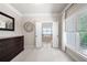 Main bedroom with tray ceiling, dark furniture, and an open door to the main bathroom at 2470 Anderson Estates Ct, Marietta, GA 30064