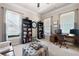 Bright office features built-in bookshelves, a desk, and two windows providing ample natural light at 2470 Anderson Estates Ct, Marietta, GA 30064
