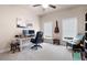 Bright office with a ceiling fan, desk, bookshelves, and natural light from two windows at 2470 Anderson Estates Ct, Marietta, GA 30064