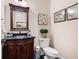 Elegant powder room with a dark wood vanity and a decorative mirror at 2470 Anderson Estates Ct, Marietta, GA 30064