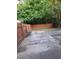 Backyard featuring a wood fence, a cracked concrete patio, and shade trees at 3530 Hopkins Ct, Powder Springs, GA 30127