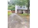 Two-story home with gray siding and a brick base with driveway and fenced-in backyard at 3530 Hopkins Ct, Powder Springs, GA 30127