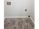 Laundry room with hardwood floors and white trim at 3530 Hopkins Ct, Powder Springs, GA 30127
