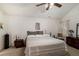 Bright bedroom featuring a large bed, ceiling fan, and neutral decor at 4378 Chestnut Oaks Trce, Lithonia, GA 30038