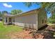 View of the exterior with siding, a well maintained lawn and partial view of a sunroom at 4378 Chestnut Oaks Trce, Lithonia, GA 30038