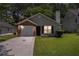 Charming single-story home with well-maintained lawn and attached one-car garage at 4378 Chestnut Oaks Trce, Lithonia, GA 30038
