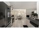 Well-lit kitchen features white cabinets, black countertops, and adjacent dining area at 4378 Chestnut Oaks Trce, Lithonia, GA 30038