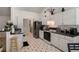 Well-lit kitchen features white cabinets, black countertops, and black & white floors at 4378 Chestnut Oaks Trce, Lithonia, GA 30038