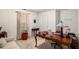 Bright home office featuring large wooden desk and window with natural light at 4378 Chestnut Oaks Trce, Lithonia, GA 30038