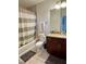 Well-lit bathroom with a shower-tub combo, vanity, and neutral color scheme at 855 Peachtree Ne St # 1406, Atlanta, GA 30308