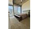 Bright bedroom with a large bed, bench, and floor to ceiling windows with a city view at 855 Peachtree Ne St # 1406, Atlanta, GA 30308