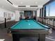 Bright billiard room with a pool table, comfortable seating, and large windows with city views at 855 Peachtree Ne St # 1406, Atlanta, GA 30308